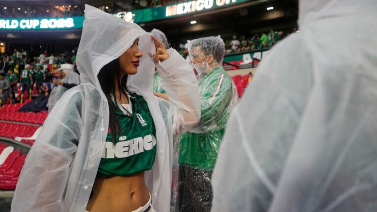A fan wears a poncho as it rains ahead of the World Cup round of 32 soccer match between Mexico and Ecuador in Mexico City, Tuesday, June 30, 2026. (AP Photo/Ricardo Mazalan)