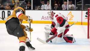 Carolina Hurricanes goaltender Brandon Bussi, right, stops a shot by Vegas Golden Knights center William Karlsson during overtime in Game 3 of the NHL hockey Stanley Cup Final series Saturday, June 6, 2026, in Las Vegas. (AP Photo/John Locher)