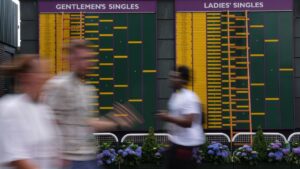 Visitors walk past the match board before the start of the Wimbledon Tennis Championships in London on Sunday, June 28, 2026.(Maja Smiejkowska/AP)