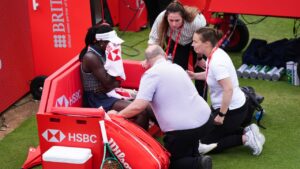Victoria Mboko, left, of Canada retires injured during her match against Karolina Pliskova of Czech Republic on day three of the Queen's Club tennis championships in London, Wednesday, June 10, 2026. (Ben Whitley/PA via AP)