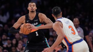 San Antonio Spurs' Victor Wembanyama, left, looks to pass around New York Knicks' Josh Hart during the second half of an NBA basketball game Sunday, March 1, 2026, in New York. (Seth Wenig/AP)