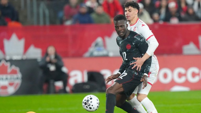 Canada's Tani Oluwaseyi, centre, fails to score as he battles with Tunisia's Alaa Ghram as goalkeeper Abdelmouhib Chamakh tries to gather the ball during second half International friendly action in Toronto, on Tuesday March 31, 2026. (Chris Young/CP)