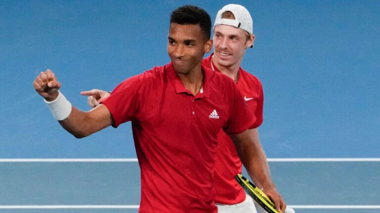 Canada's Denis Shapovalov and teammate Felix Auger-Aliassime, left, celebrate after defeating Britain's Jamie Murray and Joe Salisbury in their match at the ATP Cup tennis tournament in Sydney, Australia, Tuesday, Jan. 4, 2022. (AP-Mark Baker/CP)