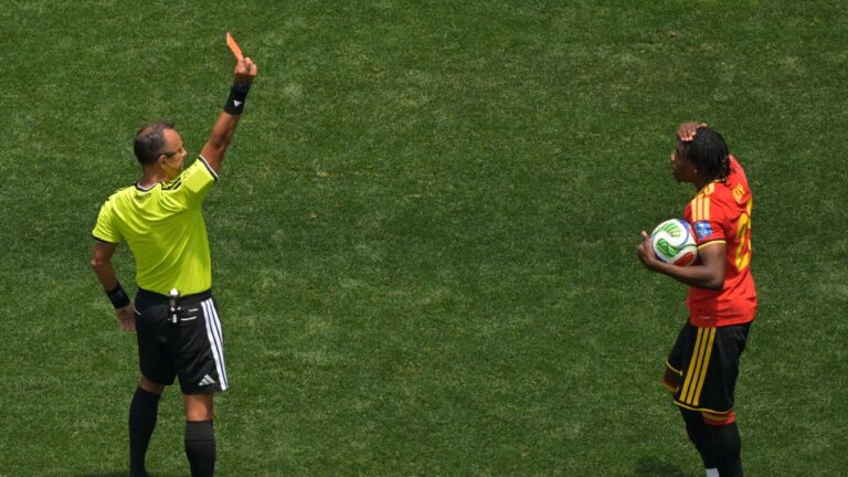 Referee Dario Herrera shows a red card to Belgium's Nathan Ngoy (25) during the World Cup Group G soccer match between Belgium and Iran in Inglewood, Calif., near Los Angeles, Sunday, June 21, 2026. (AP Photo/Jayne Kamin-Oncea)