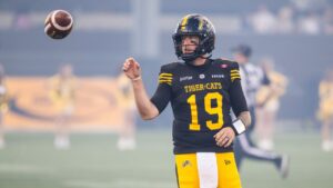 Hamilton Tiger-Cats' Bo Levi Mitchell (19) warms up ahead of CFL football action against the B.C. Lions in Hamilton on Friday, June 19, 2026. (CP/Nick Iwanyshyn)