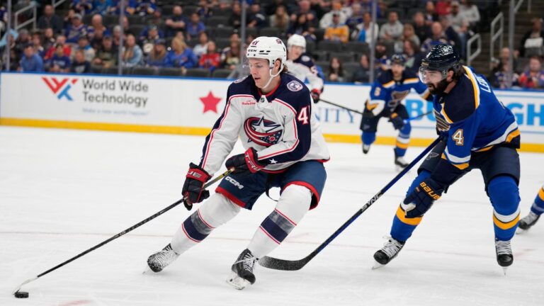 Hunter McKown reaches for a loose puck during the first period of a pre-season game on Tuesday, Sept. 26, 2023, in St. Louis. (Jeff Roberson/AP)