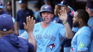 Toronto Blue Jays' Sean Keys (20) celebrates with teammates in the dugout after making his career-first major league run scored during sixth inning American League MLB baseball action against the Texas Rangers, in Toronto, Saturday, June 27, 2026. (Nathan Denette/CP)