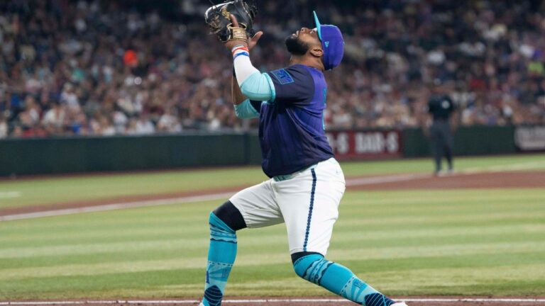 Arizona Diamondbacks first baseman Carlos Santana catches a fly ball in the fifth inning of a baseball game against the Atlanta Braces, Friday, April 3, 2026, in Phoenix. (Rebecca Noble/AP)