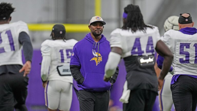 Minnesota Vikings defensive co-ordinator Brian Flores, centre, stands on the field during an NFL workout in Eagan, Minn. (Abbie Parr/AP)