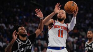 New York Knicks guard Jalen Brunson (11) shoots past San Antonio Spurs guard Stephon Castle during first half of Game 4 of the NBA Finals basketball series, Wednesday, June 10, 2026, in New York. (AP Photo/Ross D. Franklin)