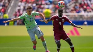 Switzerland's Michel Aebischer, left, and Qatar's Issa Laye fight for the ball during the World Cup Group B soccer match between Qatar and Switzerland in Santa Clara, Calif., near San Francisco, Saturday, June 13, 2026. (AP Photo/Eugene Hoshiko)