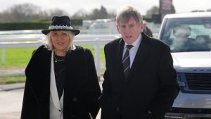 Former soccer player Kenny Dalglish and his wife Marina arrive on Day 4 of the 2026 Cheltenham Festival in Cheltenham, England, Friday, March 13, 2026. (Dave Shopland/AP)