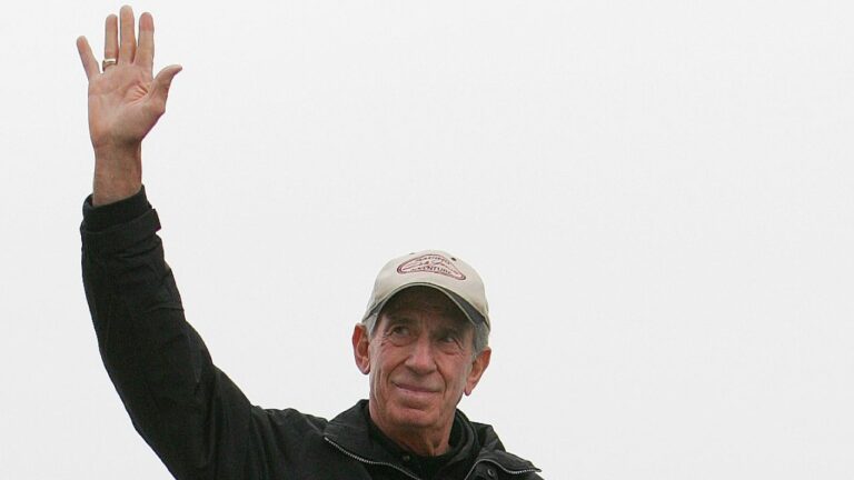 NASCAR legend Ned Jarrett waves to the fans as he is introduced before the start of the NASCAR BUSCH Nicorette 300 at Atlanta Motor Speedway in Hampton, Ga., March 18, 2006. (John Amis/AP)