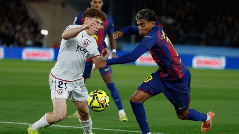 Osasuna's Victor Munoz, left, and Barcelona's Lamine Yamal fight for the ball during a La Liga match between Barcelona and Osasuna in Barcelona, Spain, Saturday, Dec. 13, 2025. (Joan Monfort/AP)