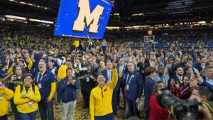 Michigan head coach Dusty May celebrates after defeating UConn in the NCAA college basketball tournament national championship game on April 7, 2026, in Indianapolis. (Michael Conroy/AP)