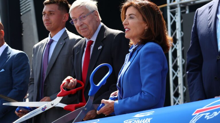 Buffalo Bills owner Terry Pegula, centre, and New York Gov. Kathy Hochul, right, participate in the ribbon cutting ceremony at Highmark Stadium in Orchard Park, N.Y., Tuesday, June 23, 2026. (Jeffrey T. Barnes/AP)