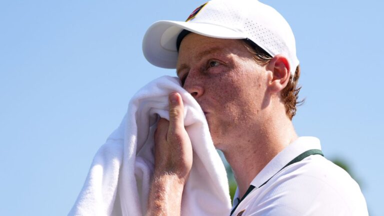 Jannik Sinner uses a towel to wipe his face during an exhibition match against Cameron Norrie at the Hurlingham Tennis Club in London on Wednesday, June 24, 2026.(Kirsty Wigglesworth/AP)