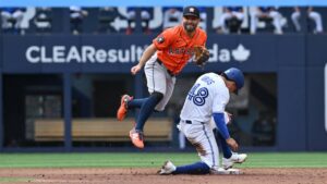 Houston Astros infielder Jose Altuve, left, throws to first base, after forcing out Toronto Blue Jays Luis Urias (48) during second inning MLB baseball action in Toronto on Tuesday, June 23, 2026. (Jon Blacker/CP)