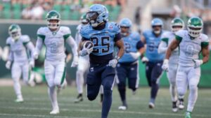 Toronto Argonauts' Samuel Hicks (25) carries the ball during first half CFL football action against the Saskatchewan Roughriders, in Regina on Friday, June 26, 2026. (Kayle Neis/THE CANADIAN PRESS)