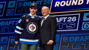 Viggo Bjorck, left, stands with NHL Commissioner Gary Bettman, right, after being drafted by the Winnipeg Jets during the NHL hockey draft Friday, June 26, 2026, in Buffalo, N.Y. (Adrian Kraus/AP Photo)