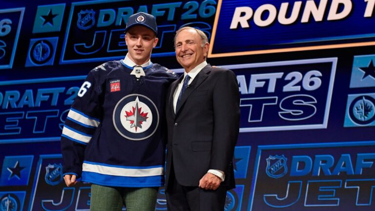 Viggo Bjorck, left, stands with NHL Commissioner Gary Bettman, right, after being drafted by the Winnipeg Jets during the NHL hockey draft Friday, June 26, 2026, in Buffalo, N.Y. (Adrian Kraus/AP Photo)