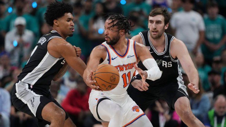 New York Knicks guard Jalen Brunson (11) spins as San Antonio Spurs guard Dylan Harper, left, defends during the first half of Game 1 of the NBA Finals basketball series, Wednesday, June 3, 2026, in San Antonio. (Eric Gay/AP Photo)