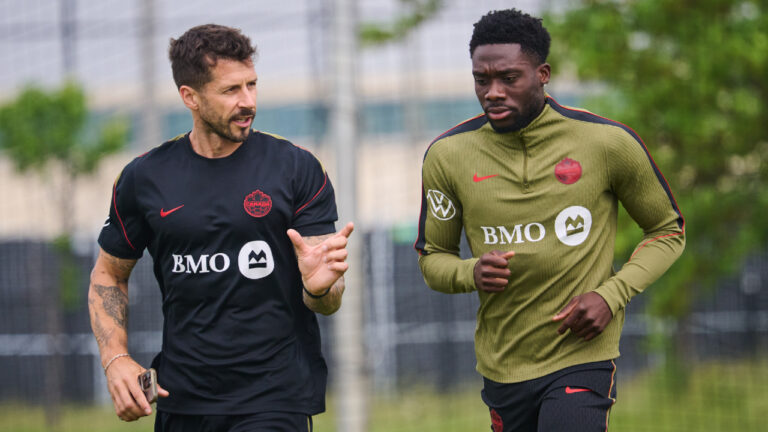 Canada's Alphonso Davies, right, runs laps during a Team Canada World Cup training session in Toronto, on Wednesday, June 10, 2026. (Sammy Kogan/CP)