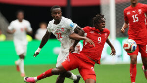 Switzerland's Johan Manzambi (9) cries out as he collides with Canada's Richie Laryea (22) during the World Cup Group B soccer match between Switzerland and Canada in Vancouver, British Columbia, Wednesday, June 24, 2026. (Sydney Shankman/AP)