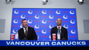 Vancouver Canucks general manager Ryan Johnson, left, and new head coach Manny Malhotra take their seats as they arrive for a news conference, in Vancouver, on Thursday, June 4, 2026. (Darryl Dyck/CP)