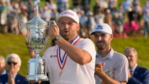 Wyndham Clark holds the trophy after winning the U.S. Open golf tournament at Shinnecock Hills Golf Club in Southampton, N.Y., Sunday, June 21, 2026. (David J. Phillip/AP Photo)