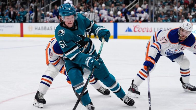San Jose Sharks right wing Collin Graf (51) and Edmonton Oilers centre Connor McDavid (97) chase after the puck during the third period of an NHL hockey game, Wednesday, April 8, 2026, in San Jose, Calif. (Godofredo A. Vásquez/AP)