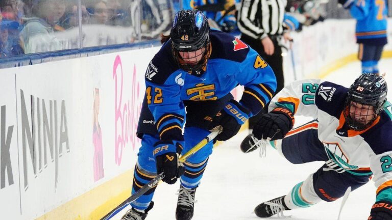 Toronto Sceptres' Claire Dalton (42) protects the puck from New York Sirens' Allyson Simpson (20) during second period PWHL hockey action in Toronto on Tuesday, April 21, 2026. (Frank Gunn/CP)