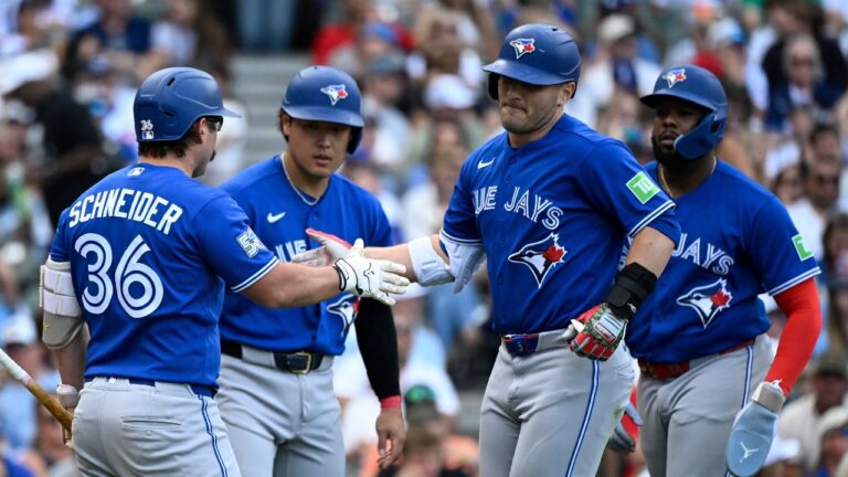Toronto Blue Jays' Daulton Varsho, second from right, celebrates with Davis Schneider (36) after hitting a three-run home run during the seventh inning of a baseball game against the Chicago Cubs, Saturday, June 20, 2026, in Chicago. (Matt Marton/AP)