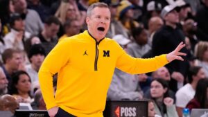 Michigan head coach Dusty May yells to his team during the first half of an NCAA college basketball game against Purdue in the championship of the Big 10 Conference tournament, Sunday, March 15, 2026, in Chicago. (Nam Y. Huh/AP)