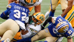 Edmonton Elks' Justin Rankin (centre) rolls across the line for the touchdown against the Winnipeg Blue Bombers during first half CFL football action in Winnipeg on Thursday, June 25, 2026. (John Woods/THE CANADIAN PRESS)