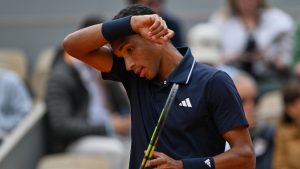 Canada's Felix Auger-Aliassime wipes his face during the quarterfinal tennis match against Italy's Flavio Cobolli at the French Open in Paris, Wednesday, June 3, 2026. (Emma Da Silva/AP)