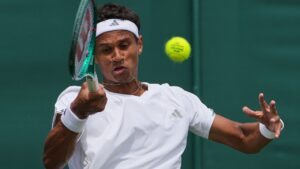 Gabriel Diallo of Canada plays a return to Benjamin Bonzi of France during the men's singles match at the Wimbledon Tennis Championships in London, Tuesday, June 30, 2026. (Kin Cheung/AP)