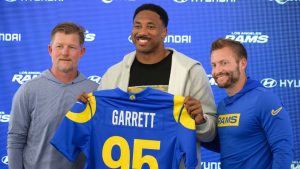 From left, Los Angeles Rams general manager Les Snead, left, defensive end Myles Garrett, and head coach Sean McVay pose for a photo during a press conference following the NFL football team's practice, Tuesday, June 2, 2026, in Woodland Hills, Calif. (Kyusung Gong/AP)
