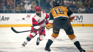 Carolina Hurricanes right wing Seth Jarvis, left, passes the puck as Vegas Golden Knights defenseman Noah Hanifin defends during the first period in Game 3 of the NHL hockey Stanley Cup Final series Saturday, June 6, 2026, in Las Vegas. (John Locher/AP)