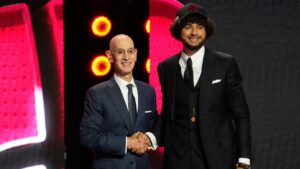 Allen Graves, right, poses for a photo with NBA Commissioner Adam Silver, left, after being selected by the Toronto Raptors as the 19th pick in the first round of the NBA basketball draft, Tuesday, June 23, 2026, in New York. (Yuki Iwamura/AP)