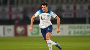 England's Harry Maguire runs with the ball during the Euro 2024 group C qualifying soccer match. (Darko Vojinovic/AP)