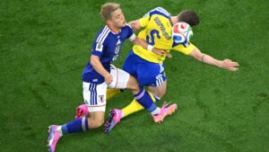 Japan's Ritsu Doan (10) challenges for the ball with Sweden's Gabriel Gudmundsson (5) during the World Cup Group F soccer match between Japan and Sweden in Arlington, Texas, near Dallas, Thursday, June 25, 2026. (Jessica Tobias/AP Photo)
