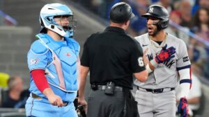 New York Yankees shortstop José Caballero (72) exchanges views with home plate umpire Steven Jaschinski as Toronto Blue Jays catcher Alejandro Kirk looks on during sixth inning MLB baseball action in Toronto on Sunday June 14, 2026. (Chris Young/CP)
