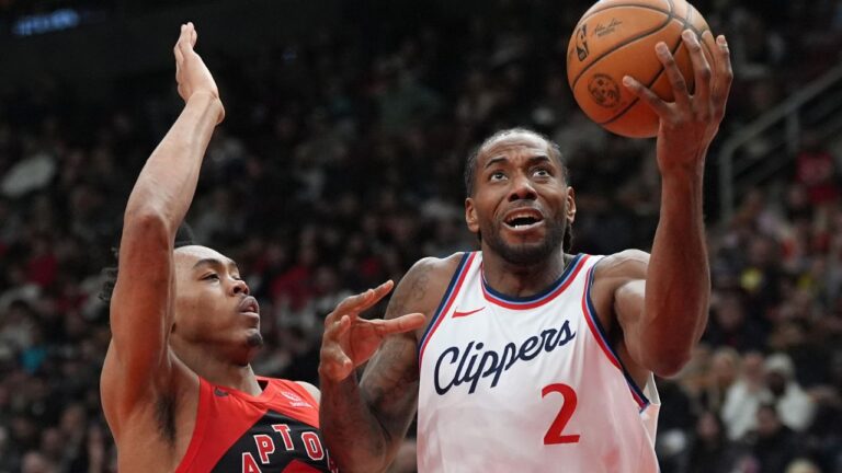 Los Angeles Clippers forward Kawhi Leonard (2) heads to the basket around Toronto Raptors forward Scottie Barnes (4) during first half NBA action in Toronto on Sunday, Feb. 2, 2025. (Frank Gunn/CP)