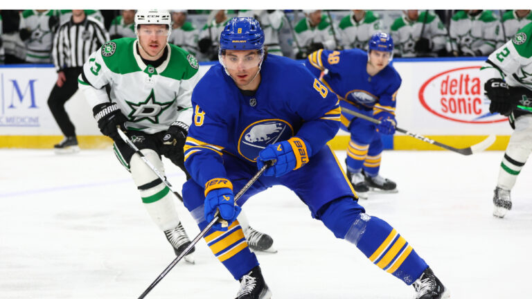 Buffalo Sabres defenceman Michael Kesselring (8) carries the puck past Dallas Stars left wing Adam Erne (73) during the first period of an NHL hockey game Wednesday, April 15, 2026, in Buffalo, N.Y. (Jeffrey T. Barnes/AP)