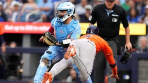 Houston Astros' Jeremy Pena (3) dives into home plate to score in front of Toronto Blue Jays catcher Alejandro Kirk (30) during first inning MLB baseball action in Toronto on Wednesday, June 24, 2026. (Chris Young/THE CANADIAN PRESS)