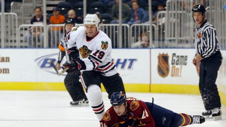 Atlanta Thrashers centre Randy Robitaille (28) goes to the ice as he vies for the puck with Chicago Blackhawks left wing Kyle Calder (19) during the first period Saturday, Oct. 18, 2003, in Atlanta. (Gregory Smith/AP)