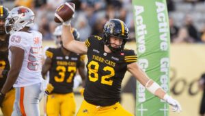 Hamilton Tiger-Cats' Maximilian Mang (82) celebrates a touchdown against the B.C. Lions during first half CFL football action in Hamilton on Friday, June 19, 2026. (Nick Iwanyshyn/THE CANADIAN PRESS)