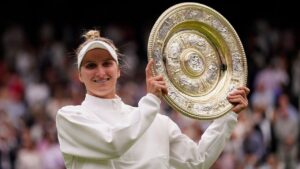 Czech Republic's Marketa Vondrousova celebrates with the trophy after beating Tunisia's Ons Jabeur to win the final of the women's singles on day thirteen of the Wimbledon tennis championships in London, Saturday, July 15, 2023. (Alberto Pezzali/AP)