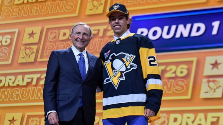Liam Ruck, right, stands with NHL commissioner Gary Bettman after being drafted by the Pittsburgh Penguins during the NHL hockey draft Friday, June 26, 2026, in Buffalo, N.Y. (Adrian Kraus/AP Photo)